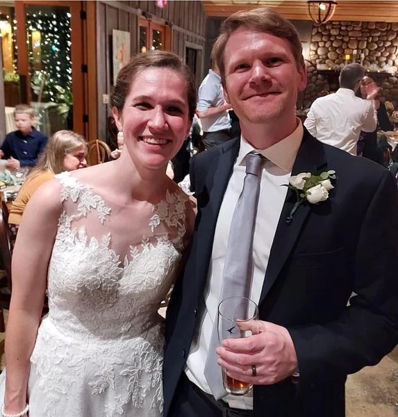 A smiling wedding couple at their reception