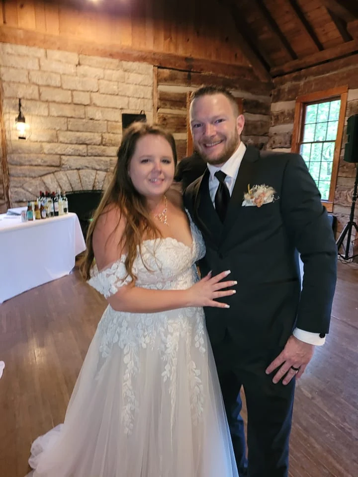 A wedding couple celebrating at a rustic reception venue