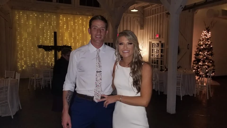 Newlyweds celebrating in a reception space with string lights