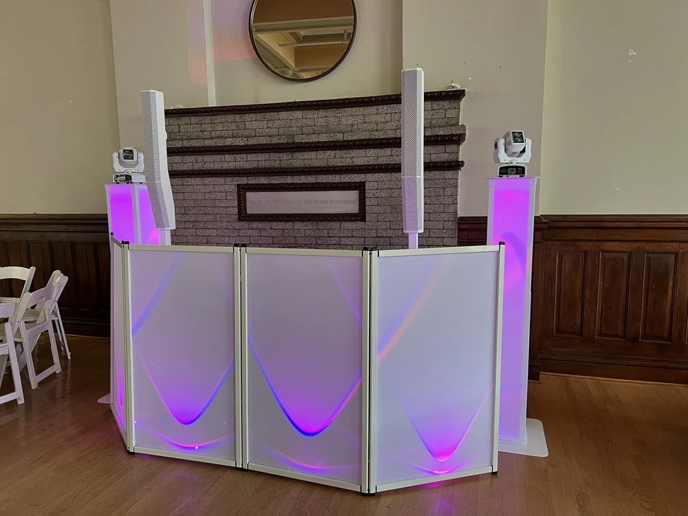 White S and D DJ booth with pink and purple lighting