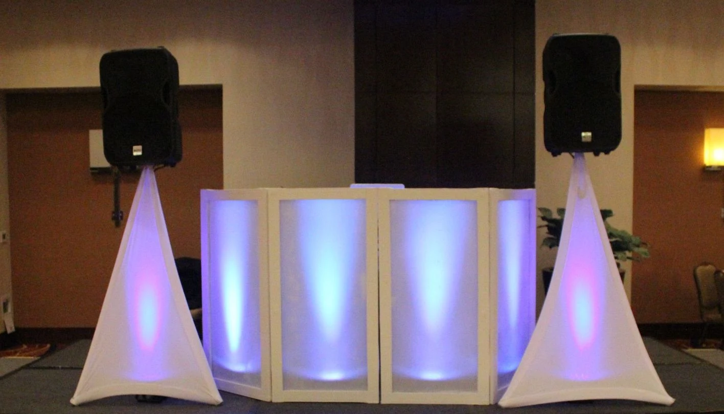 S and D DJ booth and speakers illuminated for a reception