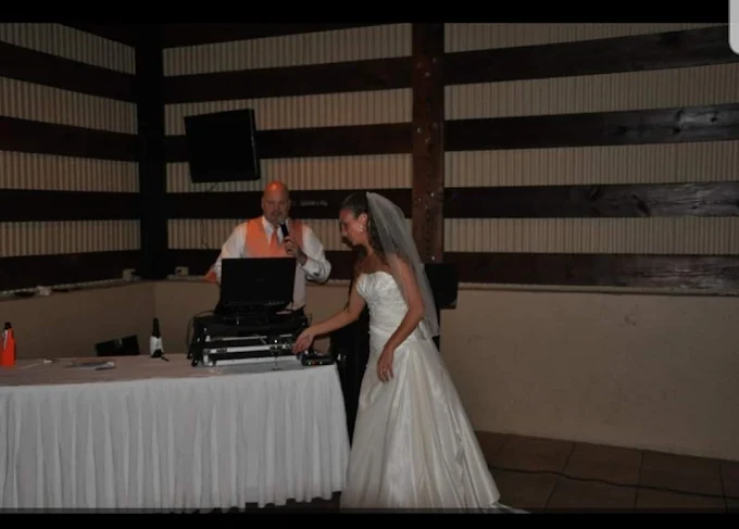 Steve hosting at the DJ table beside a bride